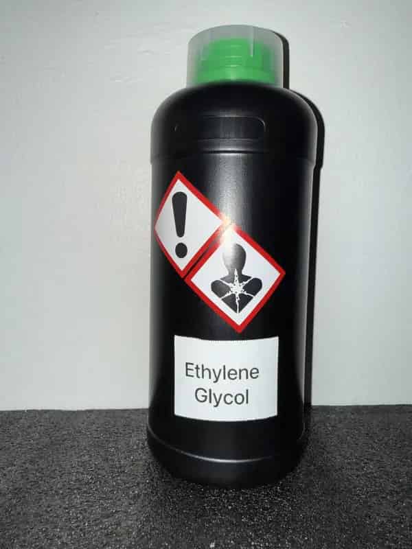 HDPE bottle of Ethylene Glycol (Antifreeze) labeled with GHS icons: Health Hazard, Irritant
