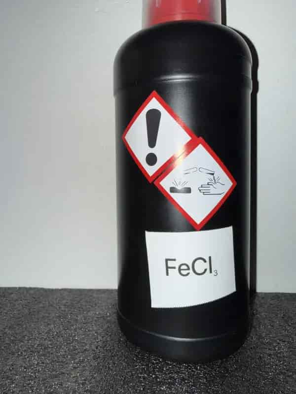 HDPE bottle of Ferric Chloride (Iron (III) Chloride) labeled with GHS icons: Corrosive, Irritant