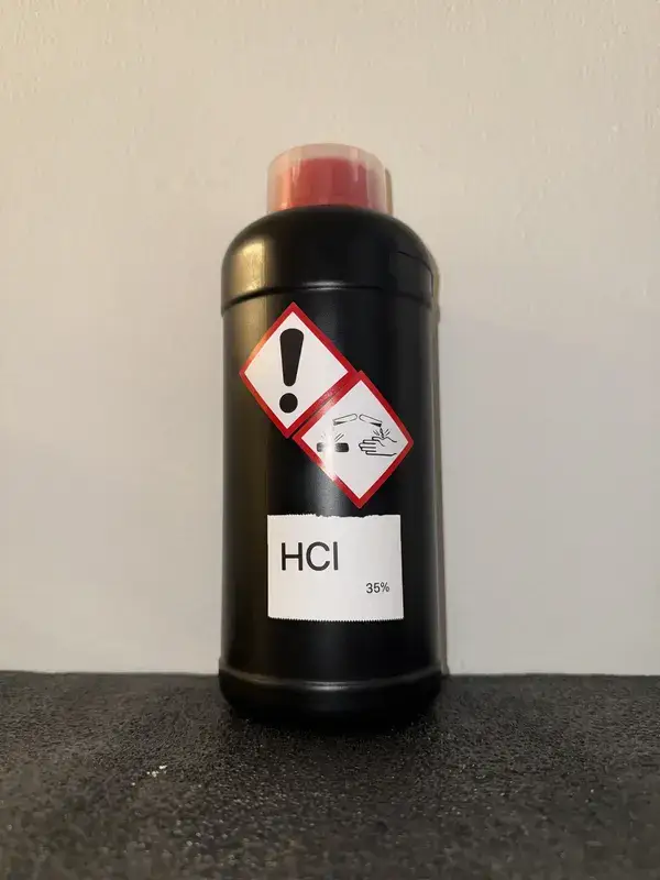 HDPE bottle of HCl (35%) labeled with GHS icons: Corrosive, Irritant