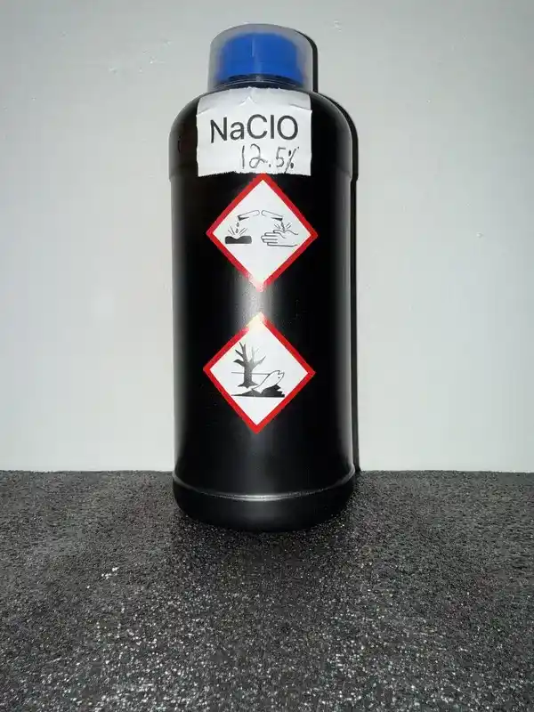 HDPE bottle of NaClO (12.5%) (Bleach) labeled with GHS icons: Corrosive, Environmental