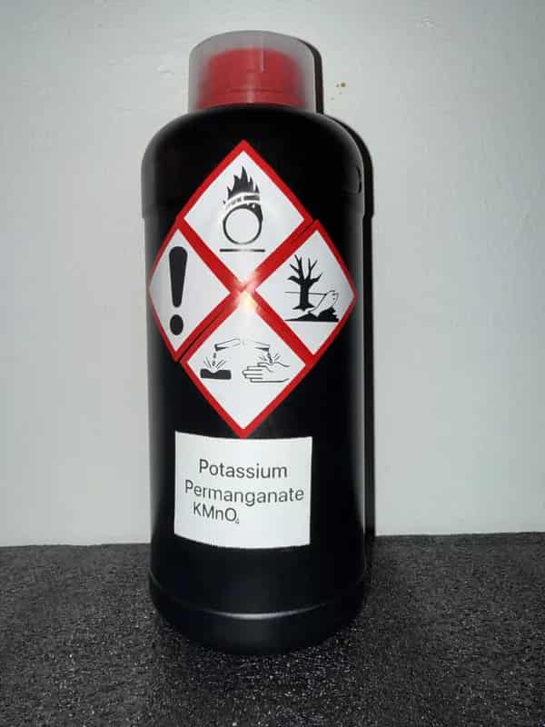 HDPE bottle of Potassium Permanganate labeled with GHS icons: Corrosive, Irritant, Environmental, Oxidizer