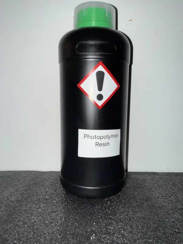 HDPE bottle of photopolymer resin labeled with GHS icons: Irritant